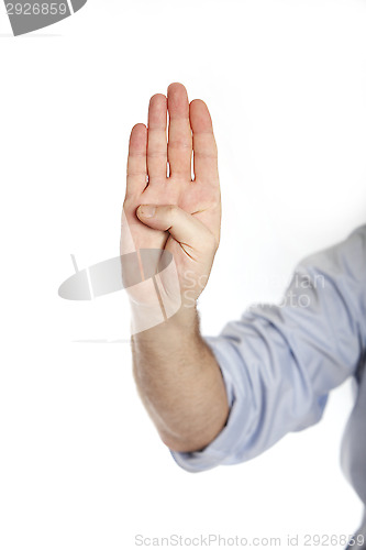 Image of Man in a blue shirt shows four fingers