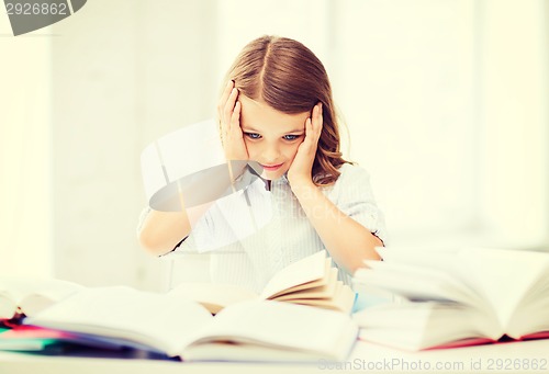 Image of pretty girl with many books at school