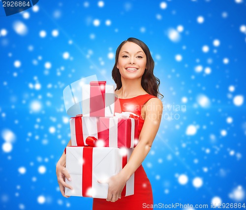Image of smiling woman in red dress with gift box