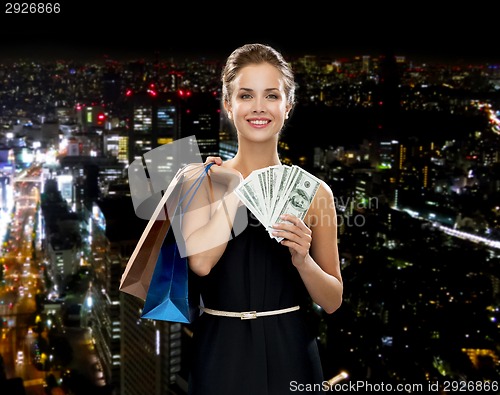 Image of smiling woman in dress with shopping bags