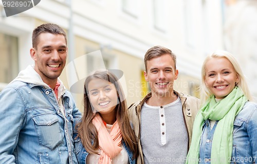 Image of group of smiling friends in city