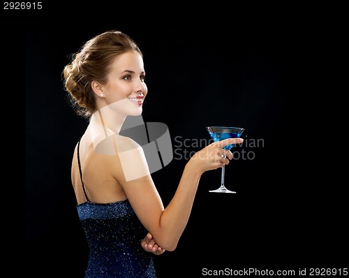 Image of smiling woman holding cocktail