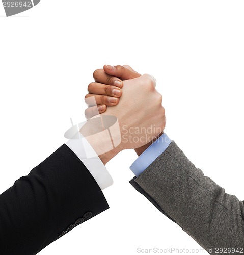 Image of hands of two people armwrestling