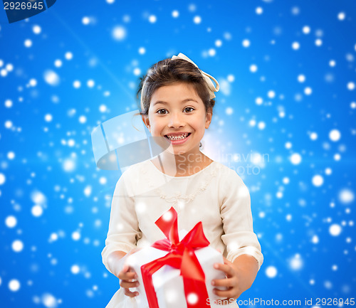 Image of smiling little girl with gift box
