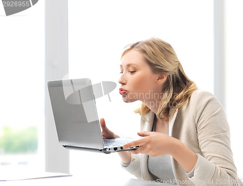 Image of woman sending kisses with laptop computer