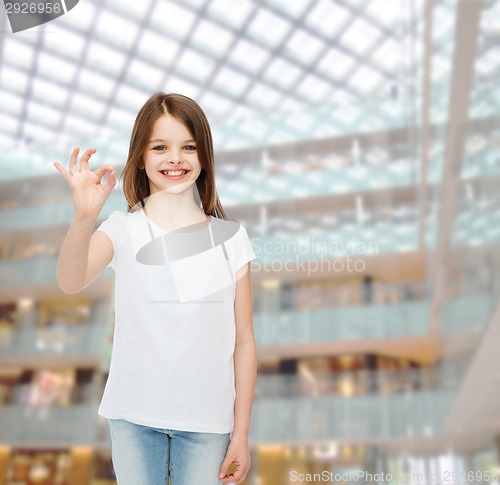 Image of smiling little girl in white blank t-shirt