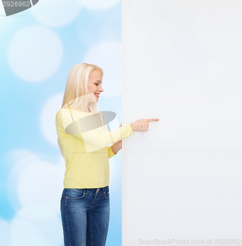 Image of smiling woman in sweater with blank white board