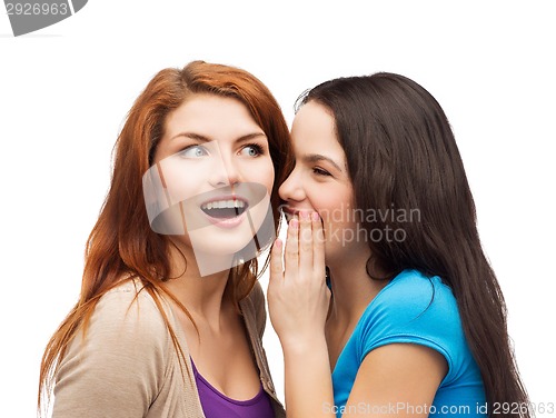 Image of one girl telling another secret