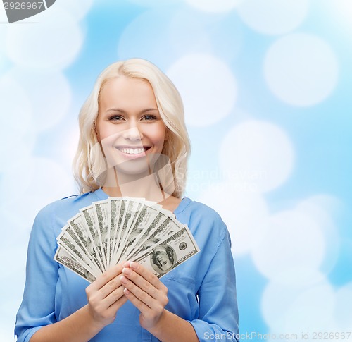 Image of smiling young woman with us dollar money