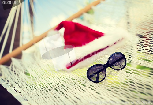 Image of hammock with santa helper hat and shades