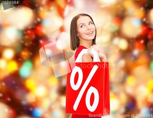 Image of woman in red dress with shopping bags