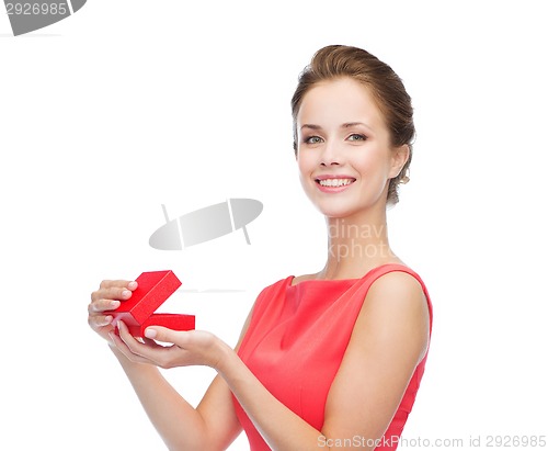 Image of smiling young woman in red dress with gift box