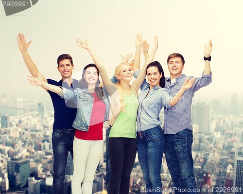 Image of group of smiling students waving hands
