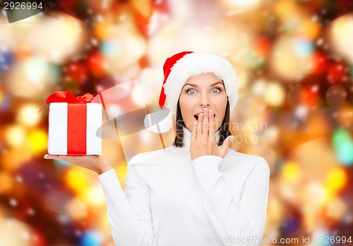 Image of smiling woman in santa helper hat with gift box