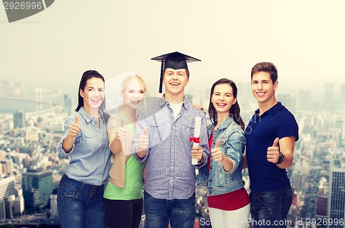 Image of group of students with diploma showing thumbs up