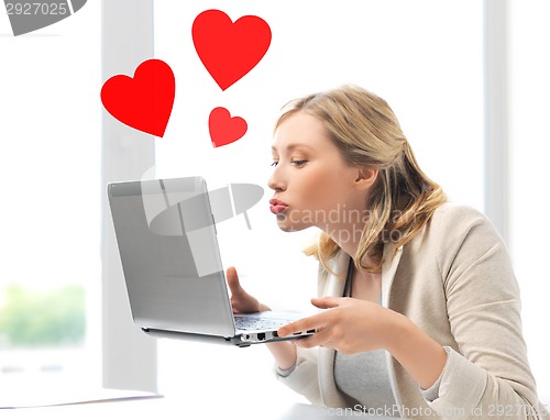 Image of woman sending kisses with laptop computer