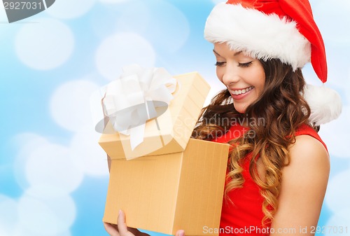 Image of smiling woman in red dress with gift boxes