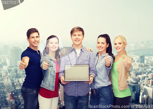 Image of smiling students with laptop computer