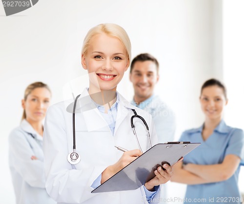 Image of smiling female doctor with clipboard