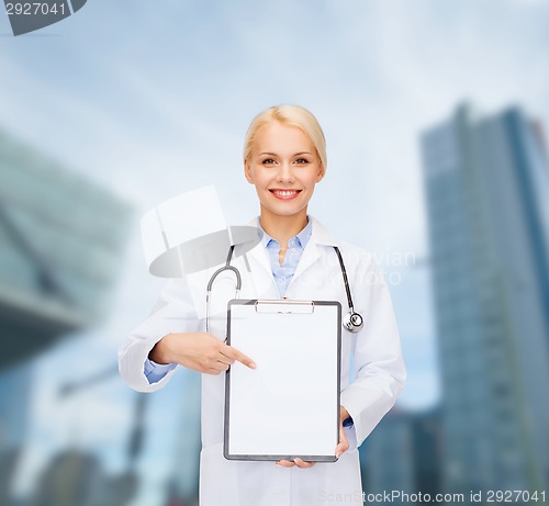 Image of smiling female doctor with clipboard