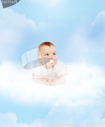 Image of smiling baby lying on cloud with dummy in mouth