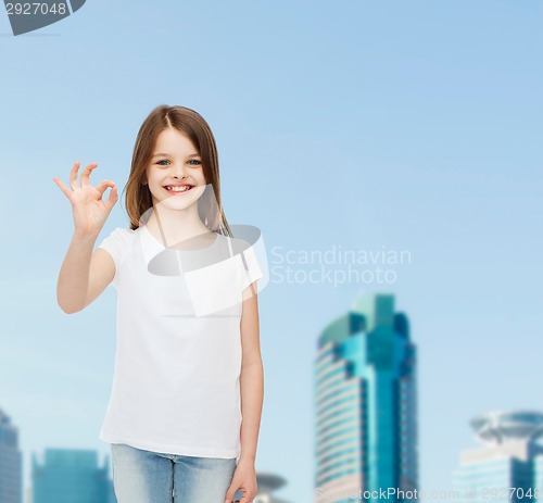 Image of smiling little girl in white blank t-shirt