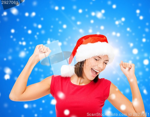 Image of smiling woman in santa helper hat