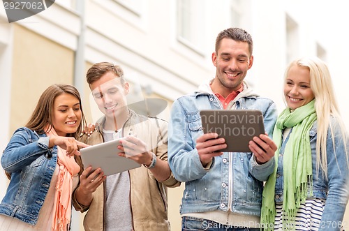 Image of group of smiling friends with tablet pc computers