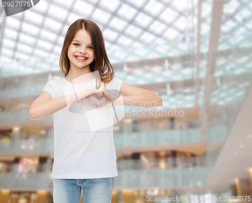 Image of smiling little girl in white blank t-shirt