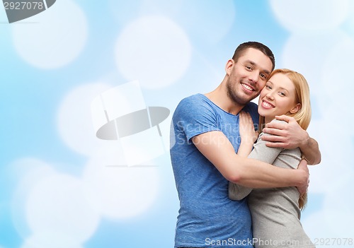 Image of smiling couple hugging