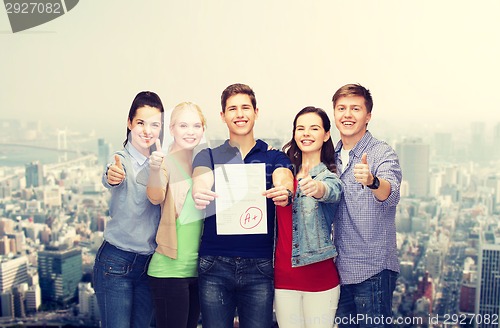 Image of group of students showing test and thumbs up