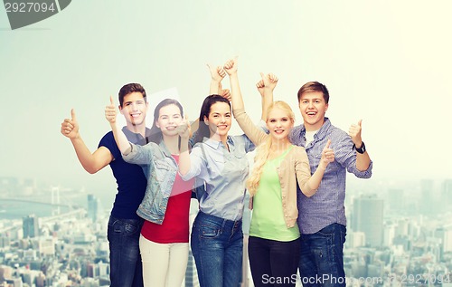 Image of group of smiling students showing thumbs up