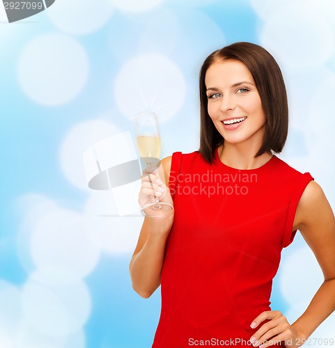 Image of smiling woman holding glass of sparkling wine