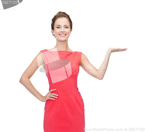 Image of smiling woman holding something imaginary on palm