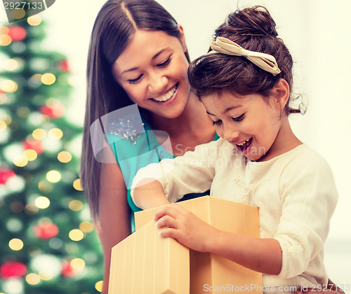 Image of happy mother and child girl with gift box