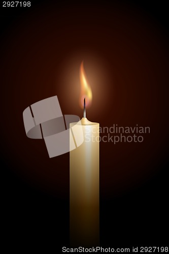 Image of Burning candle on black background.
