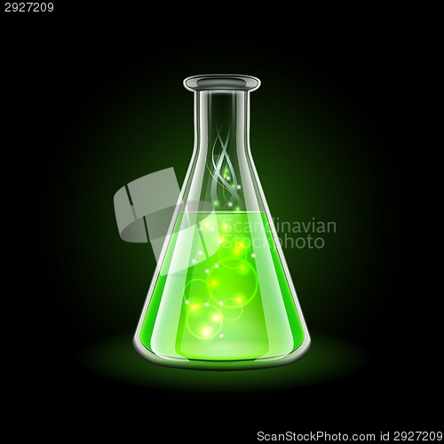 Image of Transparent flask with magic green liquid on black background.