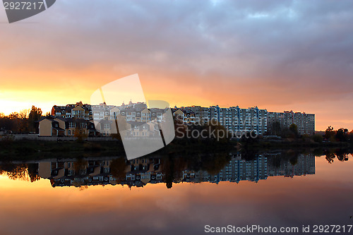 Image of landscape with river and modern house reflecting in it