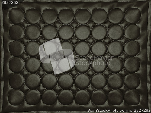 Image of Bumped black leather background with circles