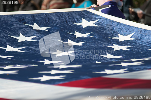 Image of american flag carried at the parade