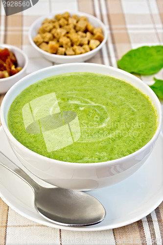 Image of Soup puree with spinach and croutons on fabric