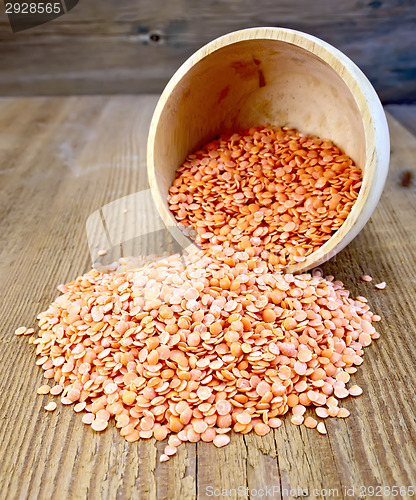 Image of Lentils red in wooden bowl on the board