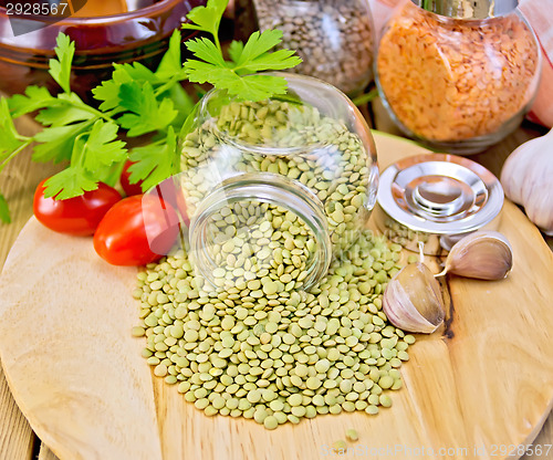 Image of Lentils green in jar with parsley on board