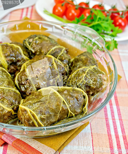 Image of Rhubarb leaves stuffed in glass dish with tomatoes