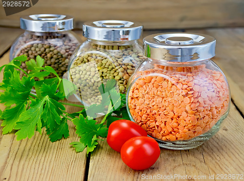 Image of Lentils different in jars with parsley on board