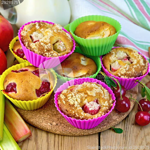 Image of Cupcakes with rhubarb and cherries in tins on board