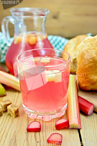 Image of Compote from rhubarb in glass and jug with bread on board