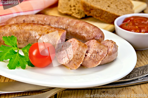 Image of Sausages pork fried in plate on board with bread