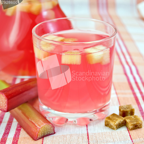 Image of Compote from rhubarb in glass and pitcher on tablecloth