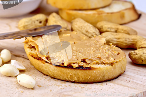 Image of Sandwich with peanut butter and knife on board